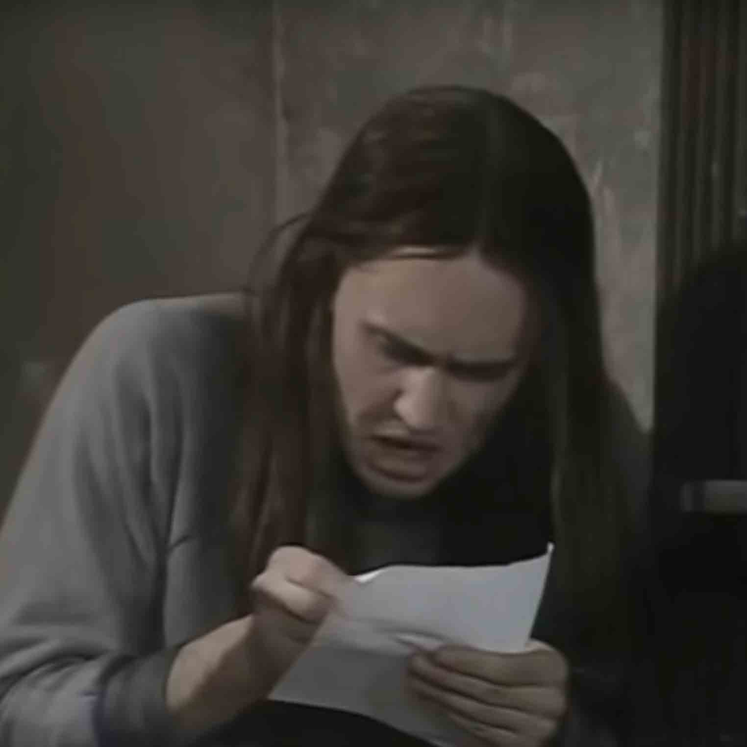 Neil from “The Young Ones” writing a letter.