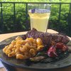 Strip steak, grilled peppers and zucchini, squash carrot pasta tossed in pesto, Hoegaarden.