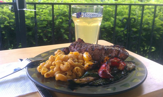 Strip steak, grilled peppers and zucchini, squash carrot pasta tossed in pesto, Hoegaarden.