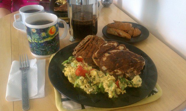 Broccoli, tomato eggs; buckwheat oatmeal chocolate chip pancakes; almond cherry biscotti with coffee.