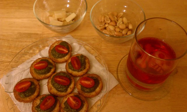 Aperitivo: Pesto tomato bread bits, espresso bellavitano, sanbitter, peanuts.