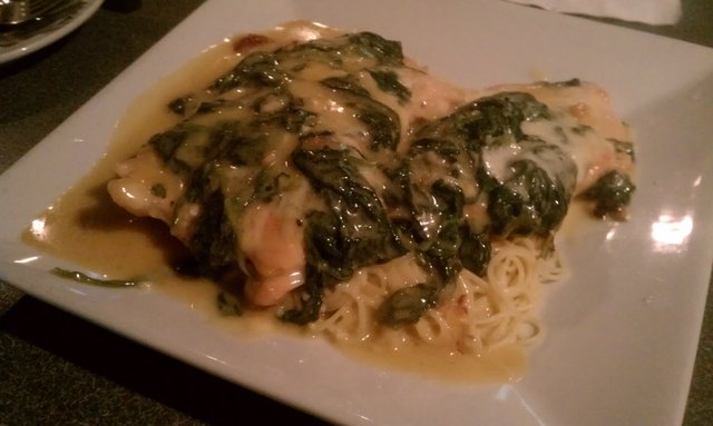 Chicken florentine on a bed of angel hair.