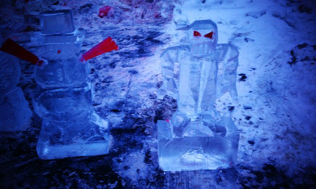 Robot and panicked snowman ice sculptures.