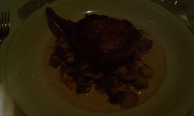 14oz. bacon-wrapped pork chop with spaetzle, carmelized brussels sprouts.