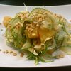 Crunchy salad of frisee lettuce, grilled pineapple, shaved fennel, chopped peanuts, sweet spicy dressing.