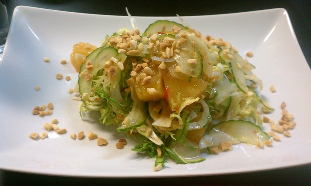 Crunchy salad of frisee lettuce, grilled pineapple, shaved fennel, chopped peanuts, sweet spicy dressing.
