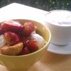 Strawberries tossed with balsamic vinegar over ice cream; cappuccino.