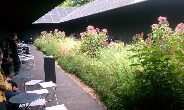 "Hortus Conclusus" by Peter Zumthore (interior) Full of folks chatting eating.