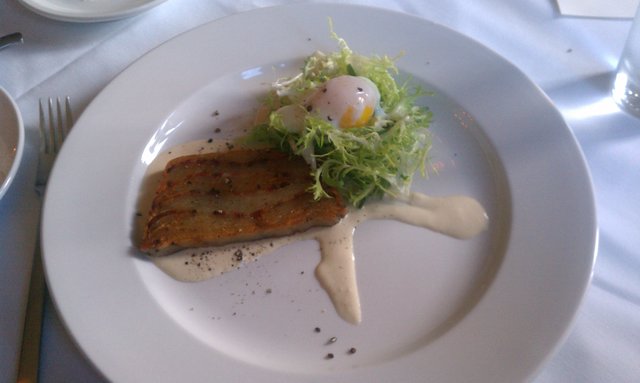 Lyonnaise Salad Terrine: poached egg, smoked bacon, frisee lettuce.