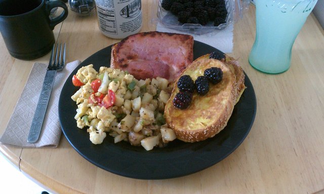 Eggs with cauliflower, peppers, tomatoes, cheddar; home fries; freedom toast, blackberries; ham steak.