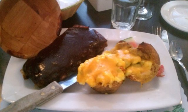 Potato skins stuffed with scrambled eggs, cheddar, Italian sausage, peppers. Side of ribs.