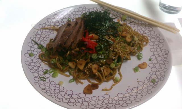 Yakisoba: stir-fried ramen, cabbage, bean sprouts, roast pork, nori, sesame seeds.