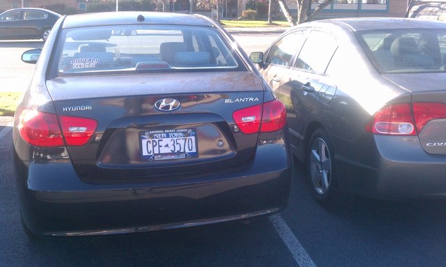 CPF-3570 Hyundai Elantra. Law school sticker, parking ticket on dash. No surprise he was so close I could hardly fit in my door.