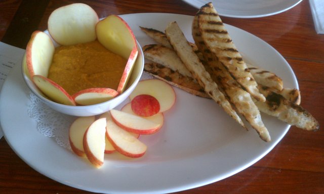 Pumpkin dip with apples and bread.