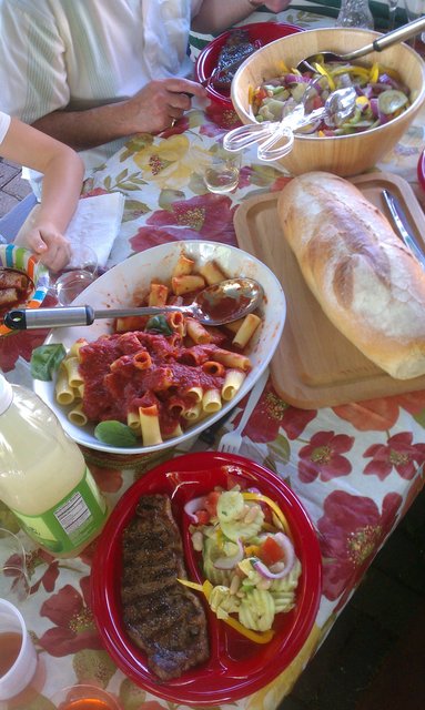 Steak, pasta, bread, awesome salad (not a pile of iceberg).