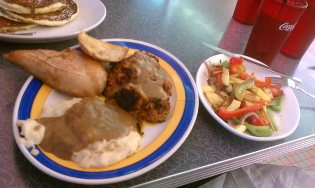 Meatloaf with tomato brown sugar glaze, garlic parmesan mashed potatoes, grilled vegetables, garlic bread.