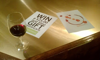 Photo of wine glass and gift card contest poster.