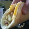 Pankegg burrito - potatoes, peppers, onions, chicken apple sausage, cheese, maple syrup wrapped in runny egg pankegg.