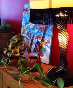 Photo of an advent calendar with a leg lamp, potted ivy, and small statue of Ganesha.
