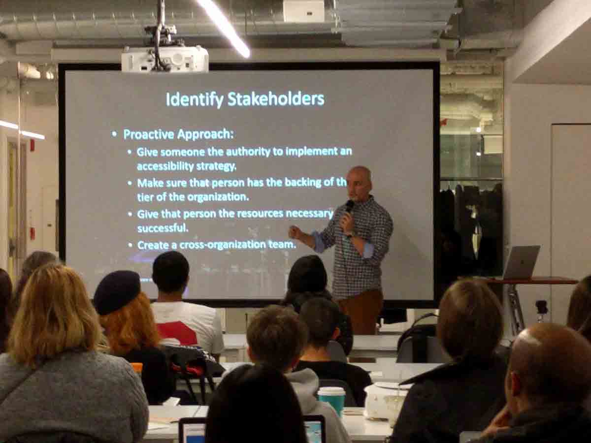 Adrian standing in front of his ‘Identify Stakeholders’ slide.