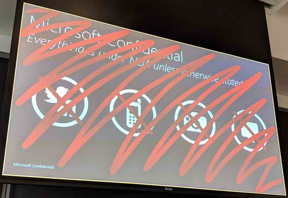 Slide showing Microsoft’s standard confidentiality policy scribbled out in red.