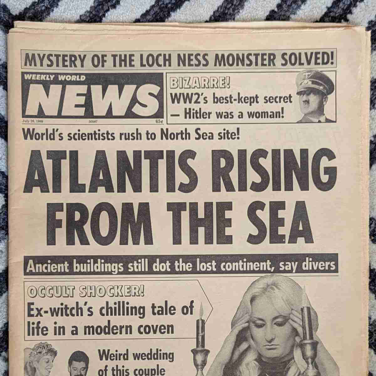 “Atlantis Rising from the Sea” with subheads “World’s scientists rush to North Sea site!” and “Ancient buildings still dot the lost continent, say divers.” Unrelated headlines: “Mystery of the Loch Ness Monster Solved!” “Bizarre! WW2’s best-kept secret — Hitler was a woman!” “Occult Shocker! Ex-witch’s chilling tale of life in a modern coven.” “Weird wedding of this couple…”